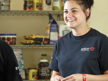 Image of Elior employee smiling in a branded T Shirt